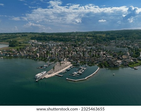 Small ship port at the lake constance. Small village in the background