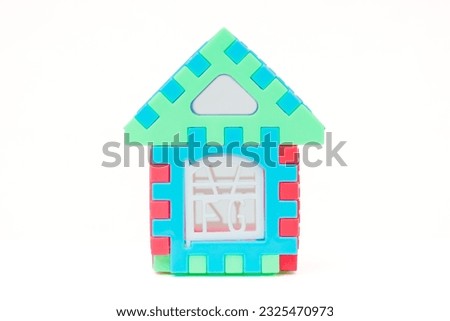 Front view of multi color building pieces block. Create house miniature isolated on white background. Children's toys house.