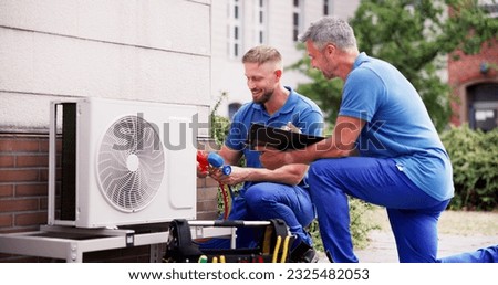 Industrial Air Conditioning Technician. HVAC Cooling System Repair Royalty-Free Stock Photo #2325482053