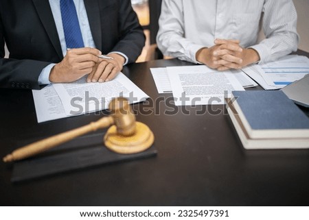 Lawyer Legal counsel presents to the client a signed contract with gavel and legal law. justice and lawyer Business partnership meeting concept