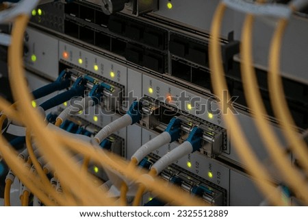 The main fiber optic channels are connected to the interfaces of a powerful router. Modern switching equipment is in the server room of the Internet data center.