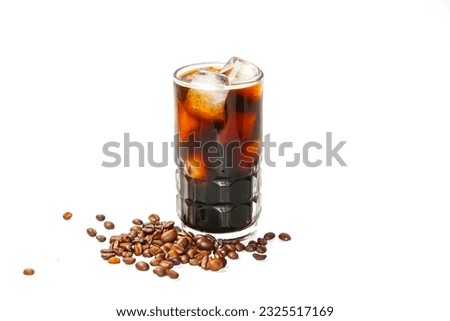 Americano ice coffee and coffee beans spread near the glass with concept isolate pictures.