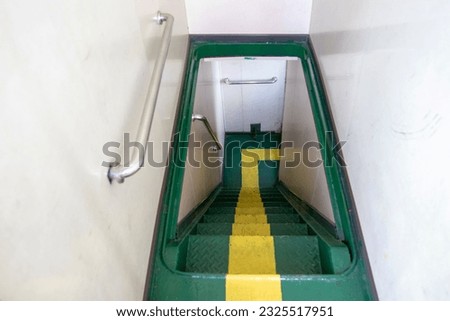 Stairs are green with yellow step markers