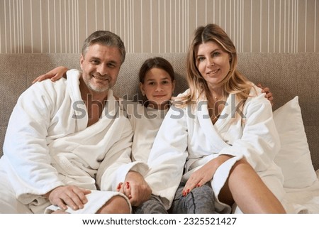 Family spending time together in the motel Royalty-Free Stock Photo #2325521427