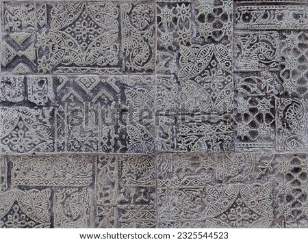 Ethnic engrave ornamental 3D molded tiles, in grey colour finishes and abstract ethnic illustration details.