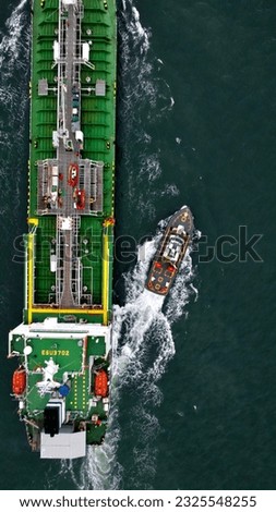 Maritime traffic, oil and gas ship, escorting tugboat, aerial view, ocean, sea, canal.