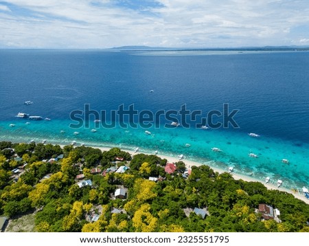 Beautiful beaches and hopping boats on Balikasak Island, Bohol, Philippines, a sacred place for scuba diving (traditional Philippine boats, banca) Royalty-Free Stock Photo #2325551795