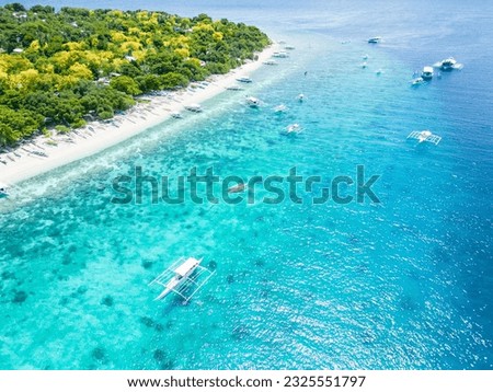 Beautiful beaches and hopping boats on Balikasak Island, Bohol, Philippines, a sacred place for scuba diving (traditional Philippine boats, banca) Royalty-Free Stock Photo #2325551797