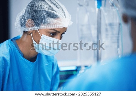 Theatre, team and surgeon woman or doctors of medical support, hospital or healthcare solution in face mask. Focus, thinking and nurses in surgery, operating room and emergency or life insurance help Royalty-Free Stock Photo #2325555127