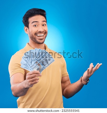 Money, studio and portrait of happy man excited for dollar bills, reward or bonus cash salary, giveaway or prize. Financial freedom, winner or person smile for income, revenue or blue background win Royalty-Free Stock Photo #2325555541