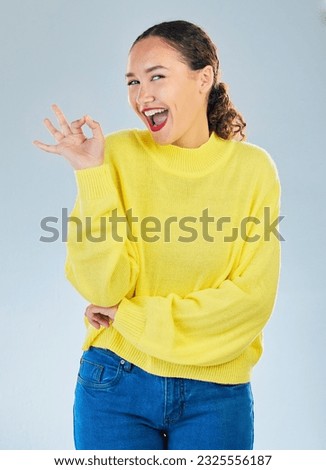 Okay, excited portrait and woman in studio, white background and vote of good review. Happy female model show ok hands for success, agreement or icon for perfect, yes emoji or satisfaction of winning