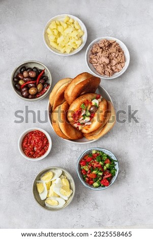 Fricasse is a savory donut filled tuna, potato,boiled egg, olives and harissa.Traditional Tunisian food Royalty-Free Stock Photo #2325558465