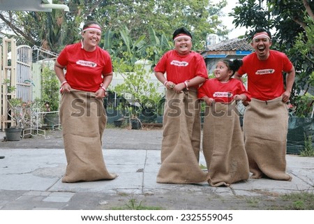 Indonesian family celebrate Indonesia independence day with outdoor contest Royalty-Free Stock Photo #2325559045