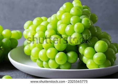 Shine Muscat, Green grapes on marble background Royalty-Free Stock Photo #2325565775