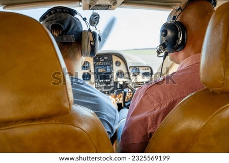View on the small planes aeroplane dashboard with buttons and charts, aircraft cockpit, pilots, piloting a plane, flight altitude control, airspeed indication and engine gauges Royalty-Free Stock Photo #2325569199