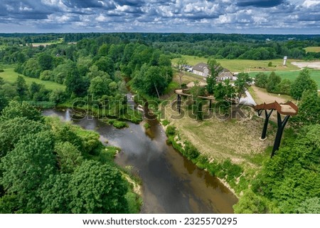 Aerial view of Pagramantis observation tower, overlooking confluence of rivers Jura and Akmena in one of Lithuanias national parks, during sunny summer day.