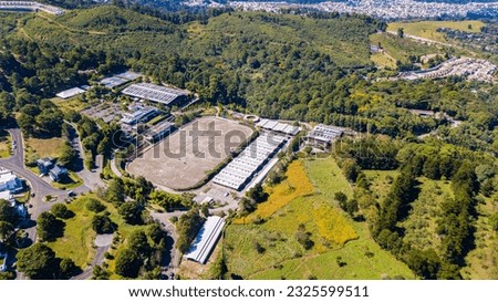 Aerial view of equestrian club, beautiful club to professionally ride horses, arena for training with horses, drone shot of beautiful landscape to work with horses.