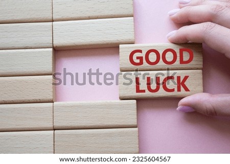 Good luck symbol. Wooden blocks with words Good luck. Businessman hand. Beautiful pink background. Business and Good luck concept. Copy space. Royalty-Free Stock Photo #2325604567