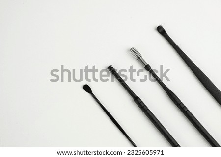 Tool set for cleaning ears isolated on a white background.