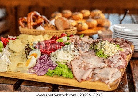 View at a typical bavarian lunch in a beer garden in summer outdoors, regional delicacy during summer season in bavaria Royalty-Free Stock Photo #2325608295