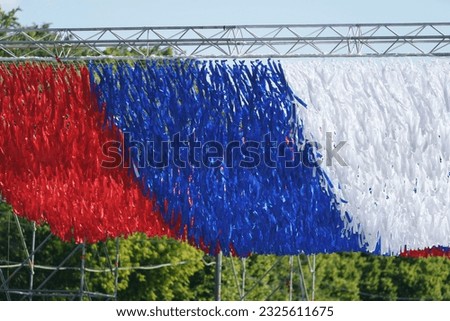 Photography of the decoration on the city Moscow street as the national flag of the Russian Federation, Tricolor. Red, Blue, White stripes. Politics concept. Close up panoramic photography. 