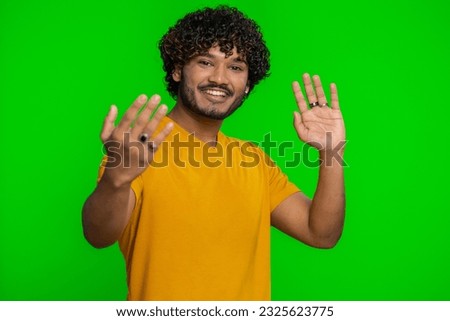 Come here, join us. Welcome. Hindu bearded man showing inviting gesture with hands, ask to join, beckoning to coming, gesturing hello, goodbye. Handsome indian guy isolated on chroma key background Royalty-Free Stock Photo #2325623775