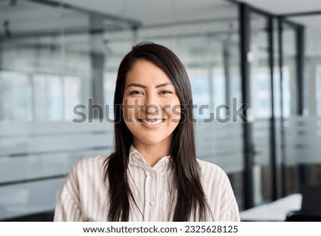 Confident smiling young professional Asian business woman corporate leader, happy japanese female employee, company sales marketing manager, standing in office, headshot portrait. Royalty-Free Stock Photo #2325628125