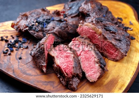 Traditional barbecue wagyu spider beef steak with black salt and spices served as close-up on a rustic wooden board  Royalty-Free Stock Photo #2325629171