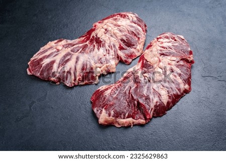 Raw wagyu spider beef steak offered as close-up on a black board with copy space  Royalty-Free Stock Photo #2325629863