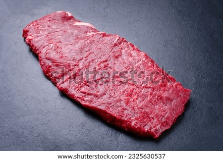 Raw wagyu skirt beef steak offered as close-up on a black board with copy Royalty-Free Stock Photo #2325630537