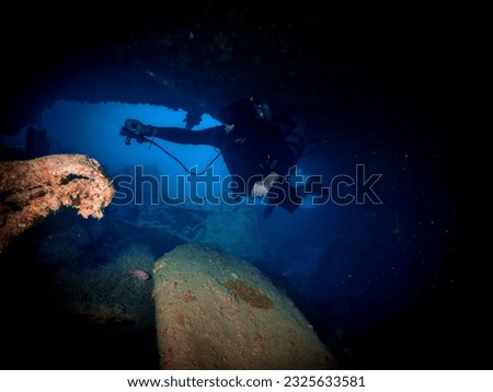 Diver Inside the ship wreck of the SS Thistlegorm in the Red Sea, Egypt.  Underwater photography and travel. Royalty-Free Stock Photo #2325633581