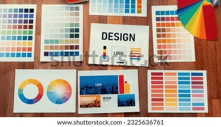 Panorama shot of various color palette idea papers arranged neatly on workspace table for graphic design concept. Color swatches and selection for unique digital art design. Scrutinize