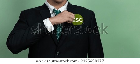 Corporate promoting sustainable and green business concept with businessman holding ESG symbol paper as environmental social government commitment using clean energy with zero CO2 emission. Alter