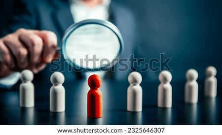 Magnifying success powerful red wooden businessman leading way. Human resource empowering corporate strategic teamwork unlocking Potential finding perfect fit HR employment discovering unique talent Royalty-Free Stock Photo #2325646307