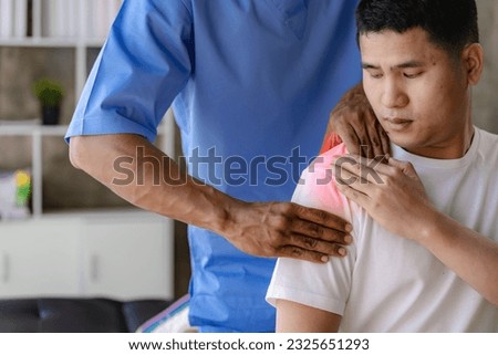 Close up patient hand doing stretching with physiotherapy to help in clinic room Therapist treats injured man with rotator cuff stretching method Royalty-Free Stock Photo #2325651293