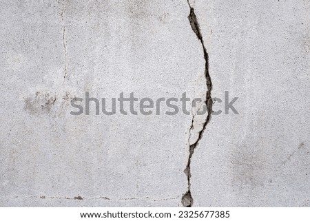 Cracked concrete wall broken wall at the outside cement corner that effected with earthquake and collapsed ground Royalty-Free Stock Photo #2325677385