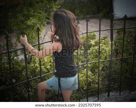 Cute girl wearing black white dresses in park .Blur background of clear focus portrait photo.different face style with present effect filter.Street poster and wallpaper images using for home decor.