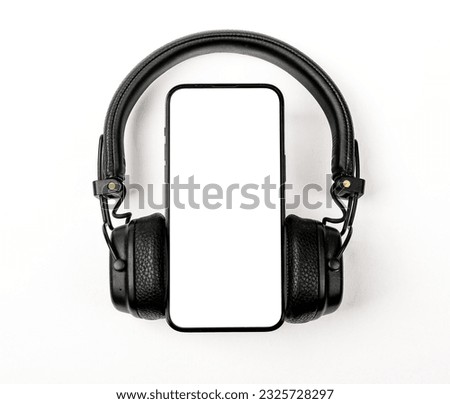 Mobile phone screen mock up and headphones.
