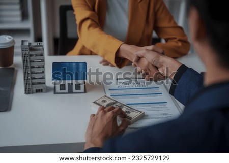 Shaking hands, Lawsuits against Real estate agent and realtor general liability insurance businessman professional discussing and consultant with house toy model building