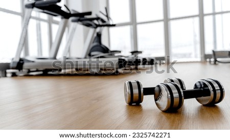 dumbbells in the gym on the floor, the concept of proper nutrition and fitness, a place for the inscription
