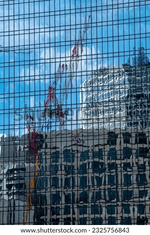 Tower Crane reflected in modern office highrise block