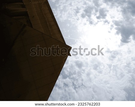 Roof or cover of brown mirrors of a structure and sky, textured photo for background