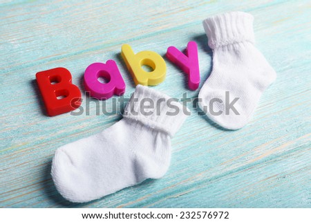 Baby word formed with colorful letters on wooden background