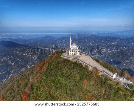Aerial Shot - MOSQUE - CLOUDS- SUN- BLACK CLOUDS- PEAK - MOUNTAIN - A MOSQUE ON THE TOP OF THE MOUNTAIN
