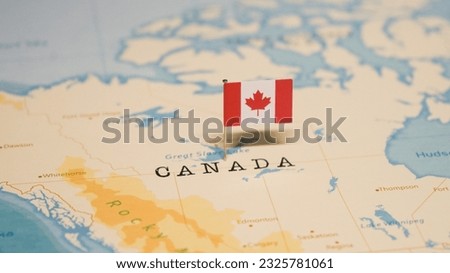 The Flag of Canada on the World Map. Royalty-Free Stock Photo #2325781061