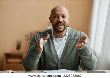 Minimal front view portrait of black man talking animatedly at camera, copy space Royalty-Free Stock Photo #2325788087