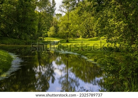 Lutynia river in beautiful garden near palace in Smielow. Poland.