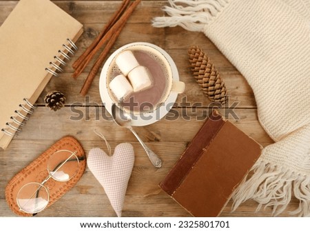 cup with drink coffee cappuccino, hot chocolate, marshmallows, garlands, winter clothes, caffeine improves functioning of human brain, stimulates nervous system, health benefits and harms, copy space