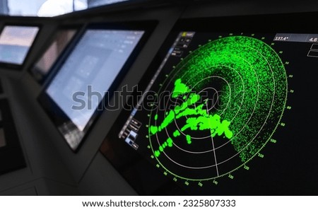 Radar screen with green display indication on a captains bridge of modern ship Royalty-Free Stock Photo #2325807333