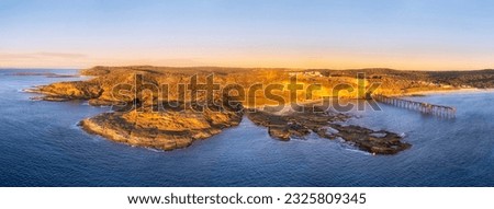 Close aerial view on sandstone rocky cape waterfront of Pacific ocean at Middle camp beach on Catherine Hill bay coast in Australia.